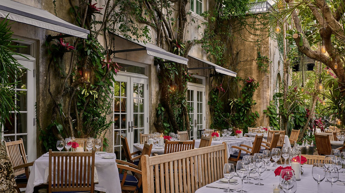 The lantern-lit garden dining room of Casa Tua in a Mediterranean villa in South Beach